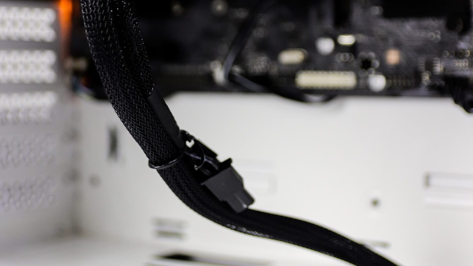 Close-up of computer hardware and a power connector inside a machine